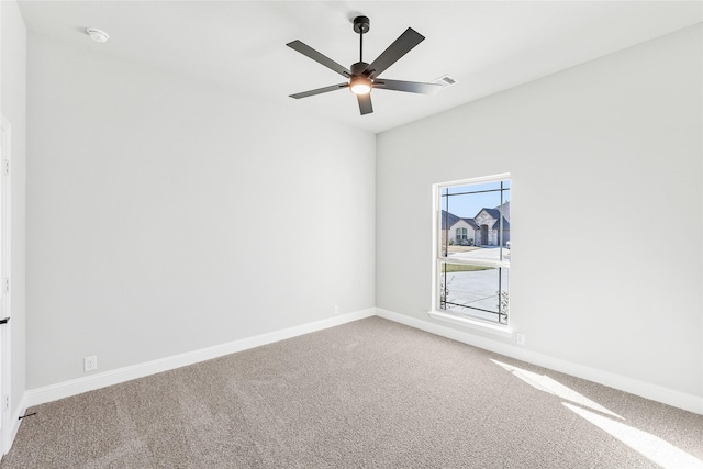 carpeted spare room featuring lofted ceiling and ceiling fan