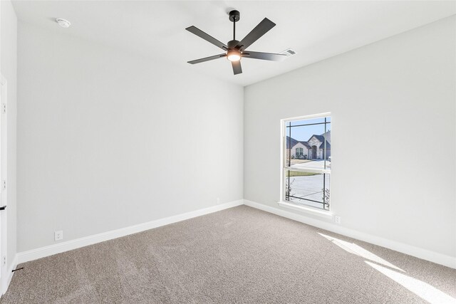 spare room featuring vaulted ceiling, ceiling fan, and carpet flooring