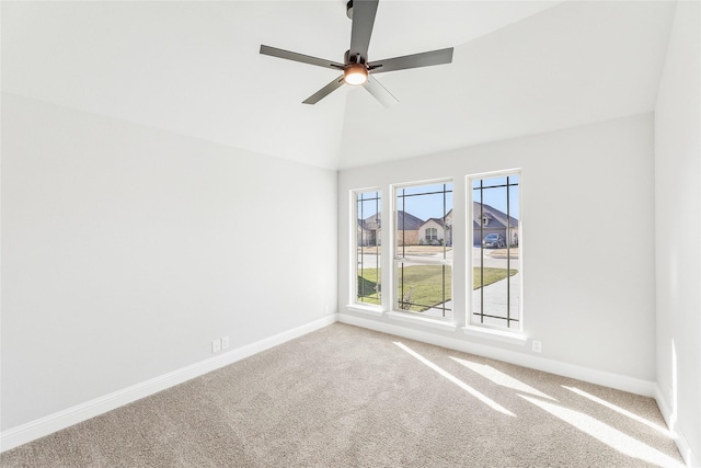 carpeted empty room with ceiling fan and vaulted ceiling