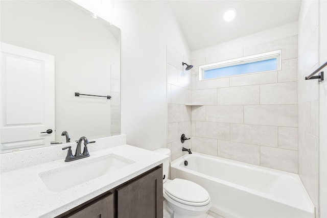 full bathroom with toilet, vanity, and tiled shower / bath