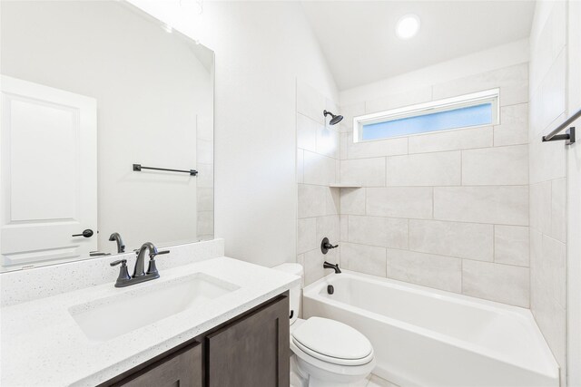 full bathroom with vanity, toilet, and tiled shower / bath