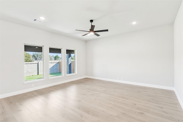 empty room featuring ceiling fan and light wood-type flooring