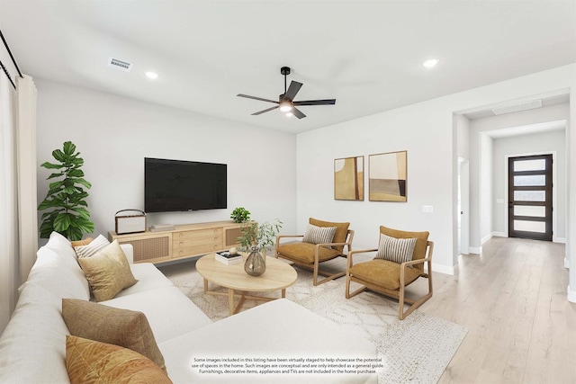 living room featuring ceiling fan and light hardwood / wood-style flooring