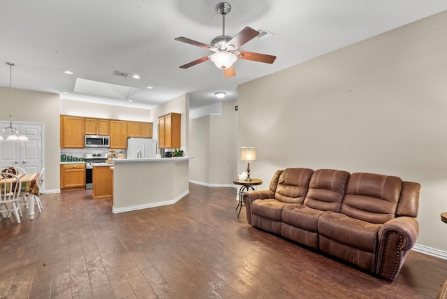 living room with ceiling fan and dark wood-type flooring