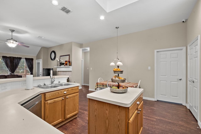 kitchen with a kitchen island, dark wood-type flooring, vaulted ceiling, sink, and hanging light fixtures