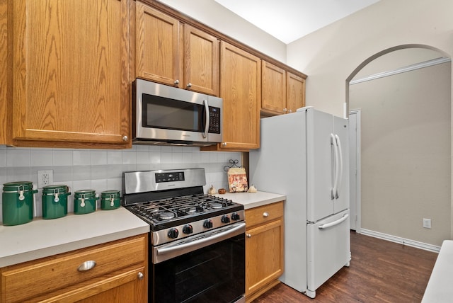 kitchen featuring backsplash, dark hardwood / wood-style floors, and appliances with stainless steel finishes