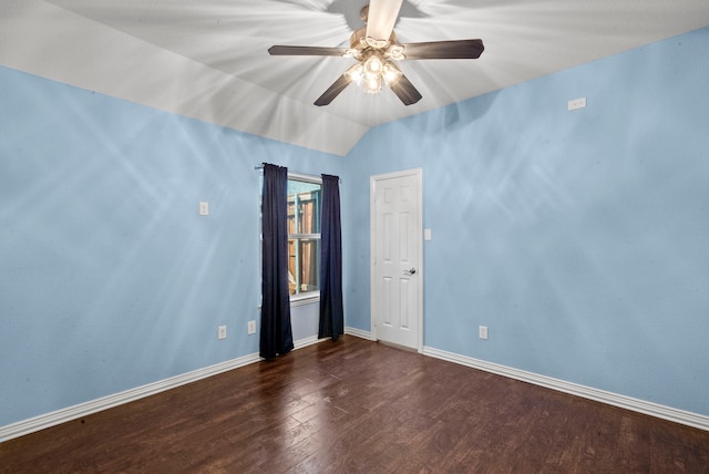 empty room with ceiling fan, vaulted ceiling, and dark wood-type flooring