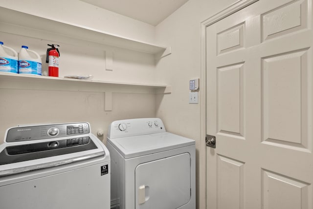 clothes washing area with washer and clothes dryer