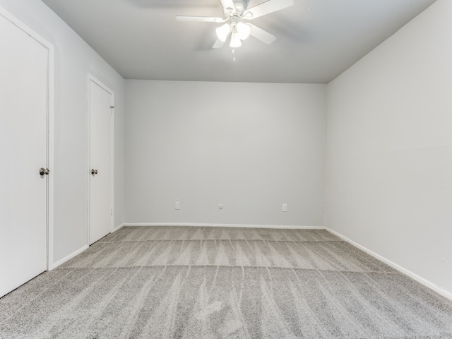 carpeted empty room with ceiling fan