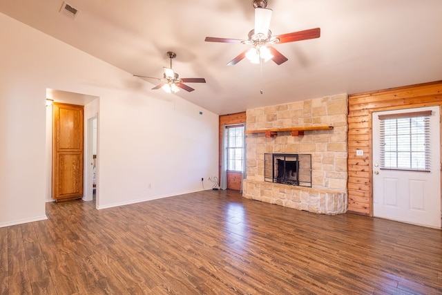 unfurnished living room with a wealth of natural light, a fireplace, dark wood-type flooring, and lofted ceiling