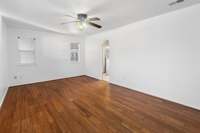 spare room featuring baseboards, ceiling fan, visible vents, and hardwood / wood-style floors