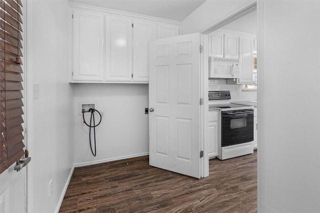 kitchen with electric stove, white microwave, dark wood-type flooring, and white cabinetry