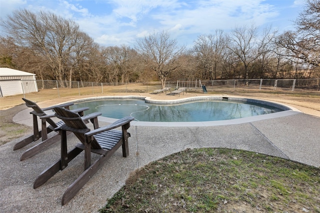 view of swimming pool featuring a patio area, fence, and a fenced in pool