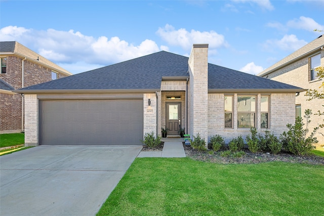 view of front of house featuring a front yard and a garage