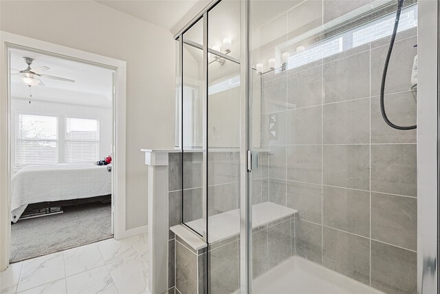 bathroom featuring a shower with door and ceiling fan