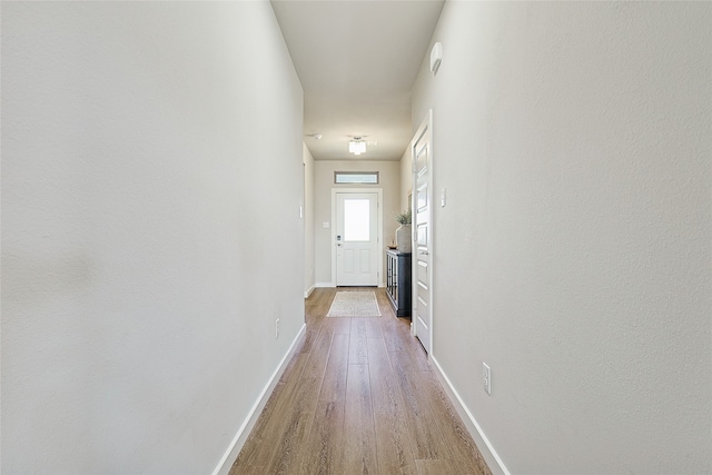 hall with hardwood / wood-style floors