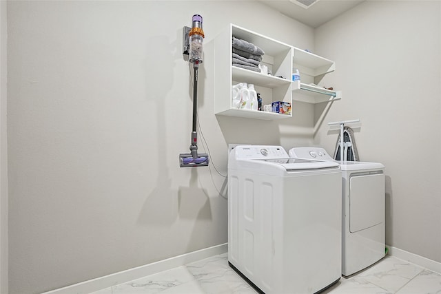 clothes washing area with washer and clothes dryer