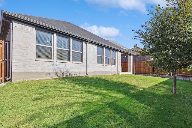 rear view of property with a yard