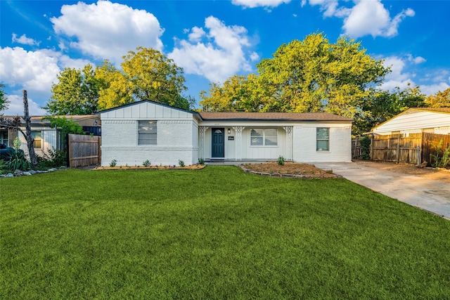 4713 San Marcus Dr, Mesquite, TX 75150 - ranch-style home featuring board and batten siding, brick siding, a front yard, and fence