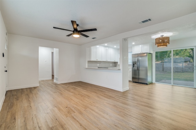 unfurnished living room with ceiling fan and light hardwood / wood-style flooring