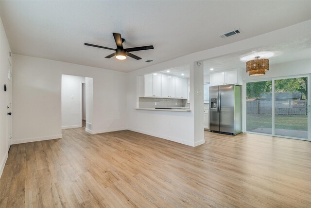 4713 San Marcus Dr, Mesquite, TX 75150 - unfurnished living room with light wood-style floors, visible vents, a ceiling fan, and baseboards