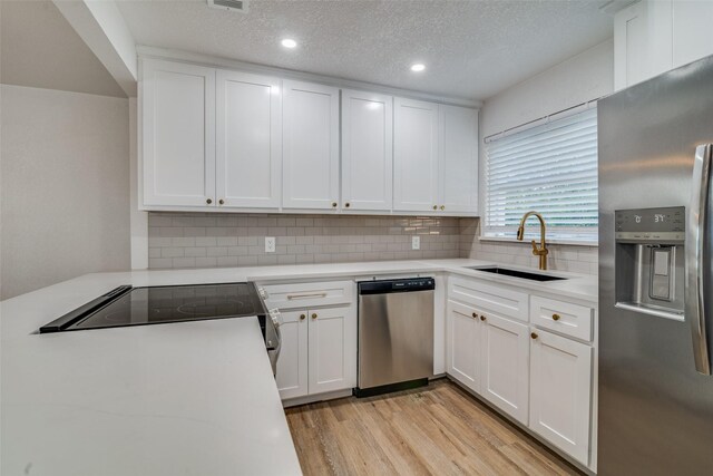 4713 San Marcus Dr, Mesquite, TX 75150 - kitchen with stainless steel appliances, light countertops, backsplash, a sink, and light wood-style floors