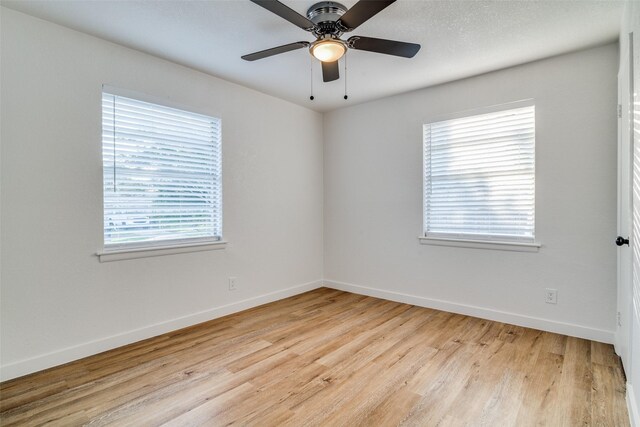 4713 San Marcus Dr, Mesquite, TX 75150 - empty room with a healthy amount of sunlight, light wood finished floors, and baseboards