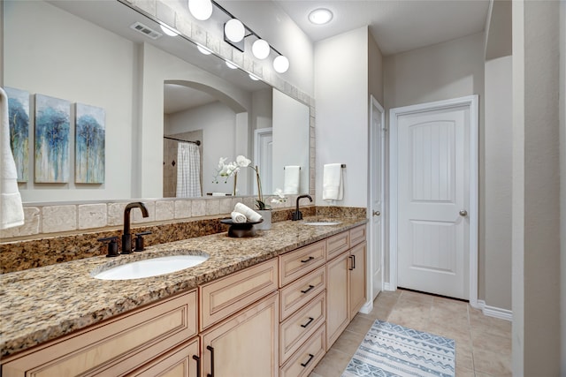 bathroom with vanity, tile patterned flooring, and curtained shower