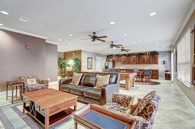 living room with ceiling fan, light tile patterned floors, and crown molding