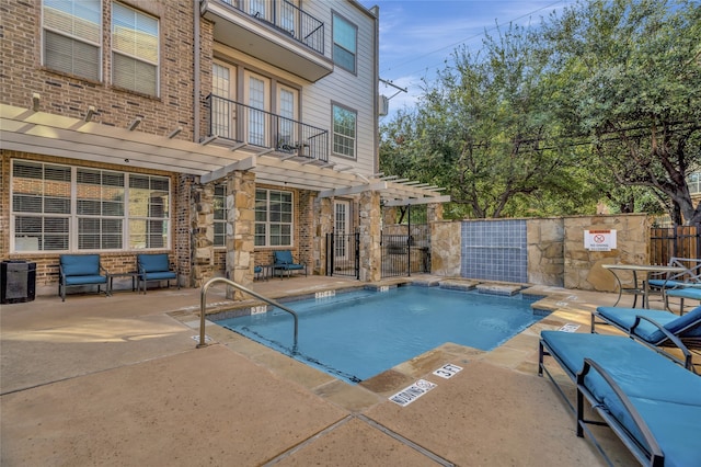 view of pool with cooling unit, a pergola, and a patio area