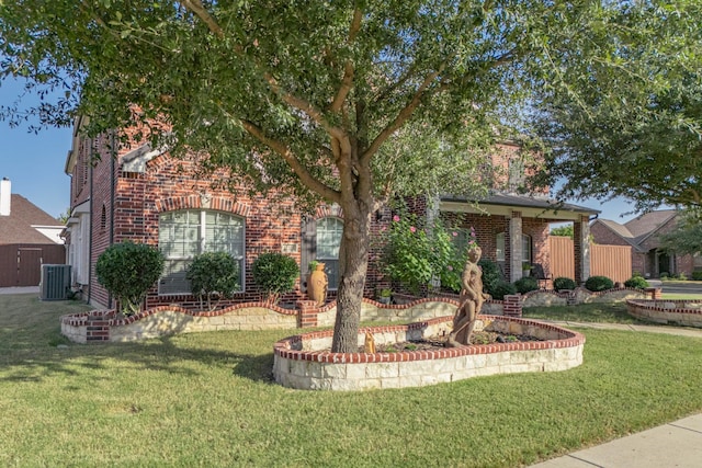 view of front of house with a front yard and central air condition unit