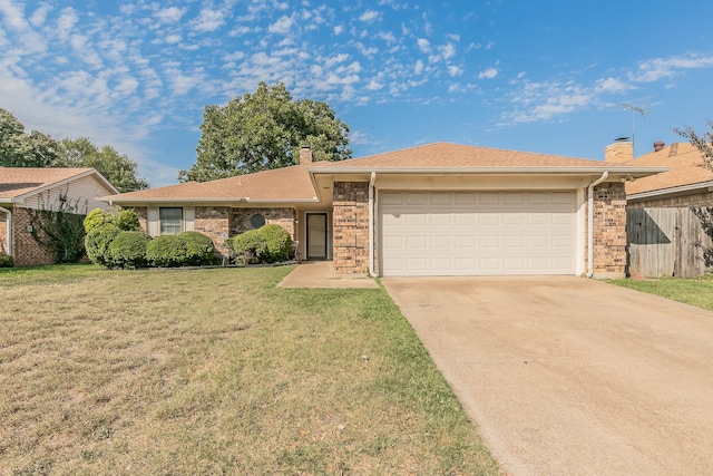 ranch-style house with a garage and a front lawn