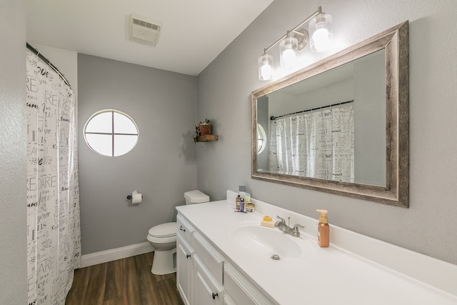 bathroom featuring wood-type flooring, vanity, and toilet