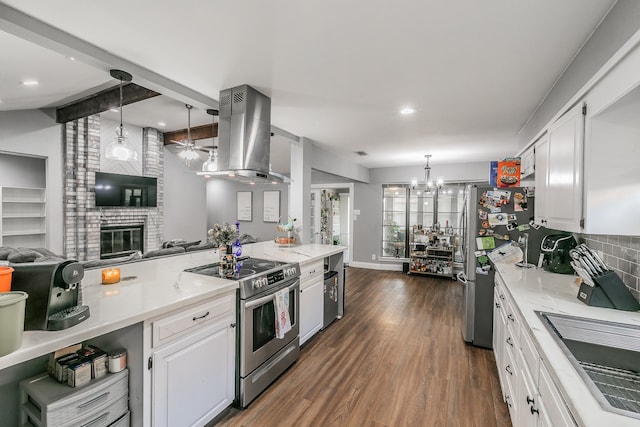 kitchen with island range hood, white cabinets, appliances with stainless steel finishes, and hanging light fixtures