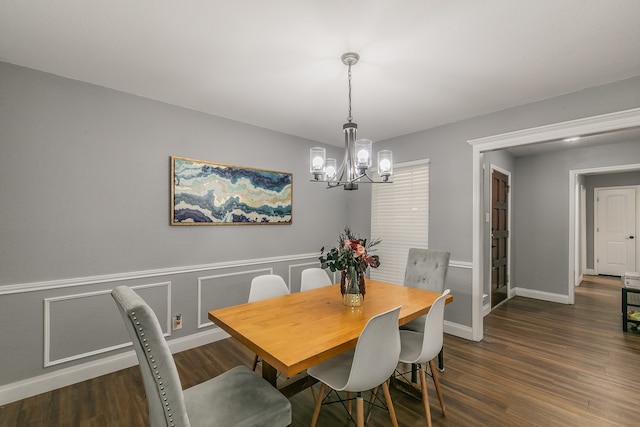 dining space with a notable chandelier and dark hardwood / wood-style floors