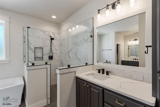 bathroom with vanity and shower with separate bathtub