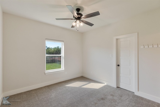 empty room with carpet flooring and ceiling fan