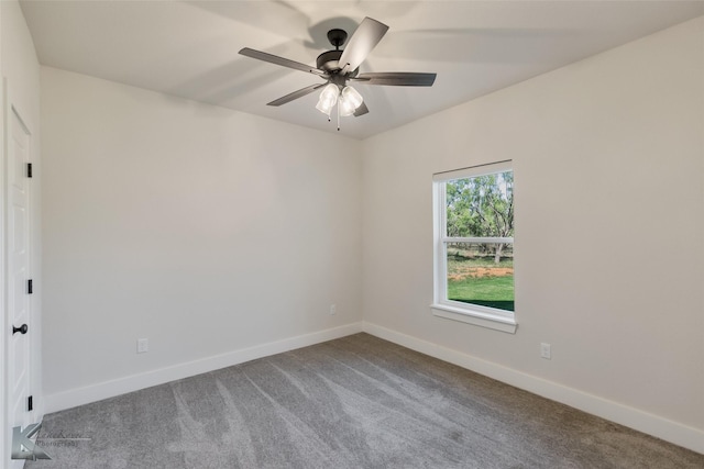 carpeted spare room featuring ceiling fan