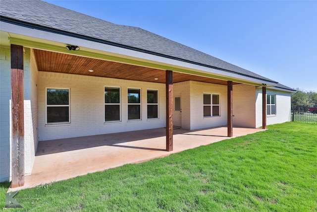 back of property featuring a patio area and a yard