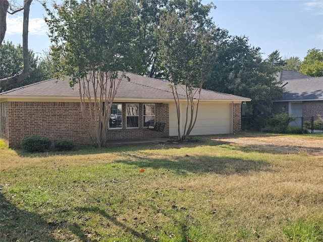 rear view of house featuring a yard and a garage