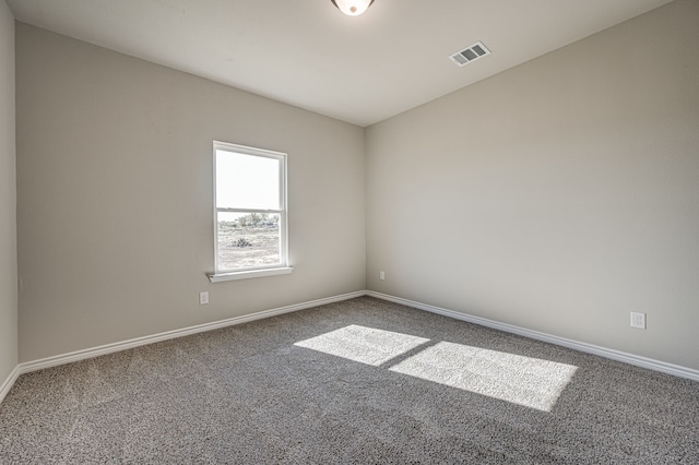 unfurnished room featuring carpet