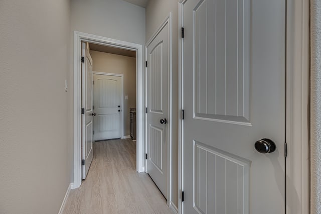 corridor with light hardwood / wood-style flooring