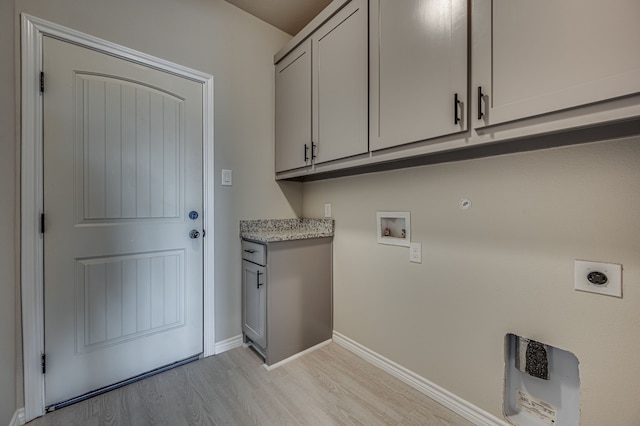 laundry area with cabinets, light hardwood / wood-style floors, electric dryer hookup, and washer hookup