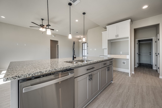 kitchen featuring a center island with sink, white cabinetry, sink, stainless steel dishwasher, and light hardwood / wood-style flooring