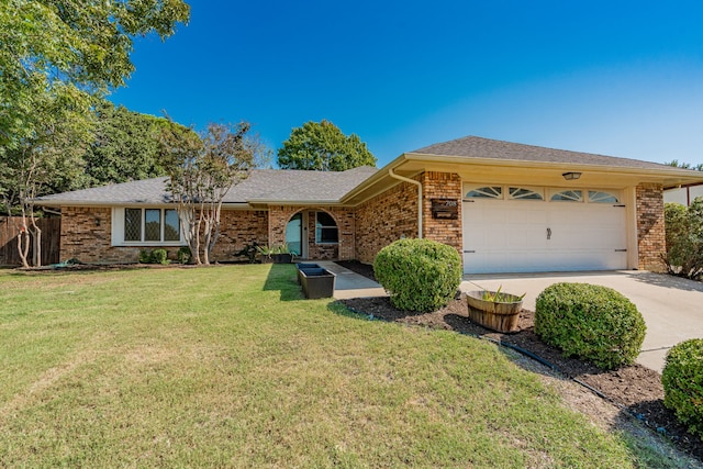 ranch-style home featuring a garage and a front yard