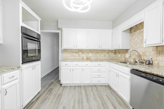 kitchen with white cabinets, black oven, and stainless steel dishwasher