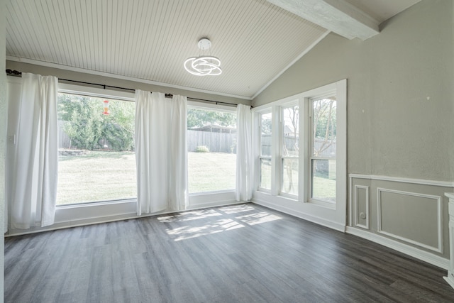 interior space featuring plenty of natural light, vaulted ceiling with beams, and dark hardwood / wood-style floors