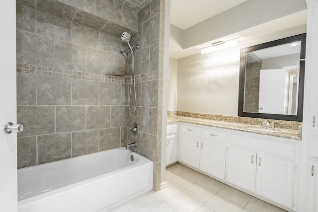 bathroom featuring tile patterned floors, vanity, and tiled shower / bath