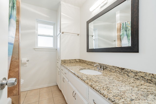 bathroom with tile patterned floors, vanity, and toilet