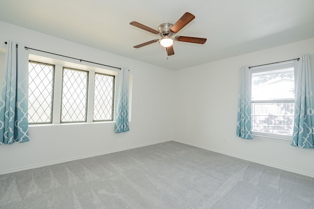 spare room featuring ceiling fan and light carpet